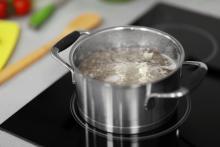 A pot of boiling water on a stove.
