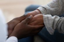 Adult holding a younger adults hands