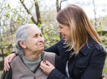 Young adult caregiver with senior outdoors