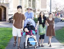 Family walk together outside on sidewalk