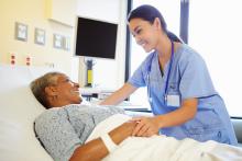 Nurse talking with patient in hospital room