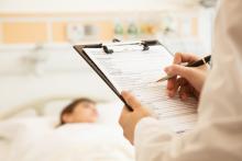 A patient's health form on a clipboard is used at a hospital.