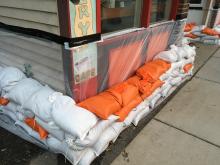 Sandbags and plastic around the outside of a building to protect from flooding