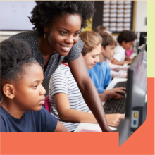 Students with a teacher in a computer lab