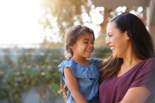 A laughing adult holding a laughing child