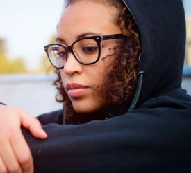 Close up of teen sitting by water