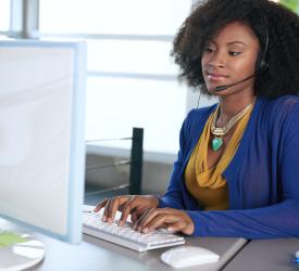 An employee with headset working on computer