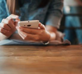 Adult hands holding a smart phone