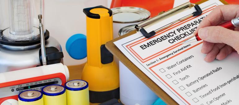 Emergency supplies shown with a checklist on clipboard Emergency supplies shown with a checklist on clipboard